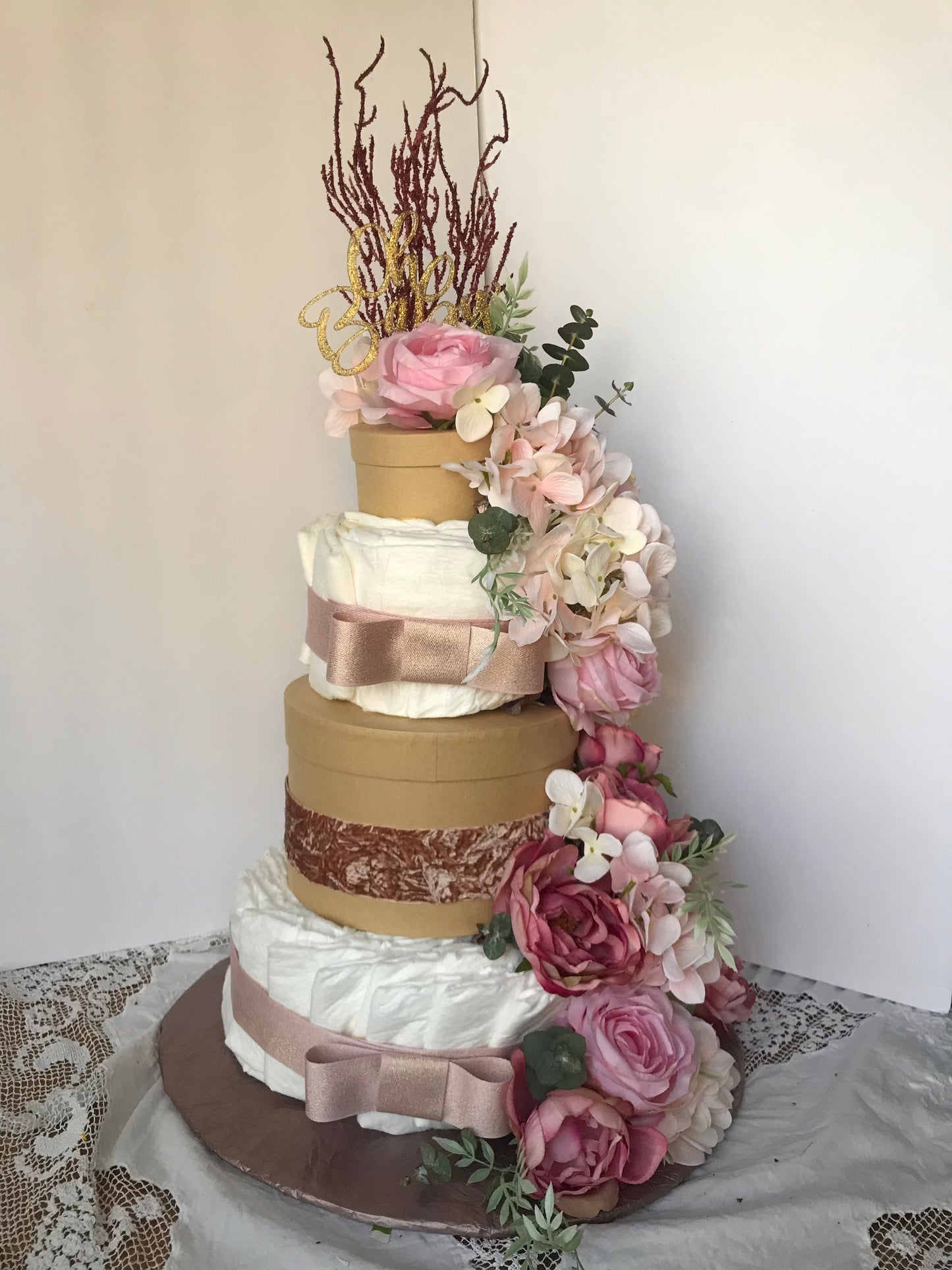 dusty rose luxury diaper cake with cascading flowers circular gift boxes