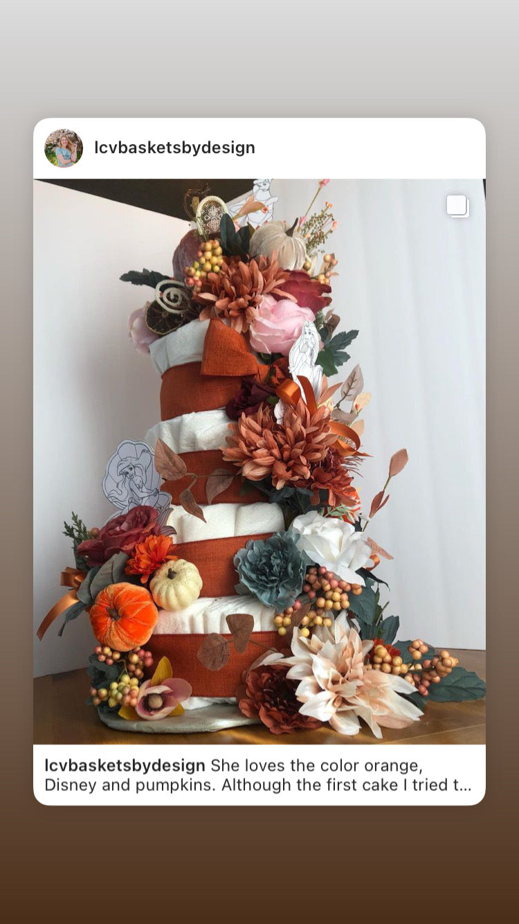 Orange and teal pumpkin diaper cake luxury size with cascading flowers and touch of whimsical 