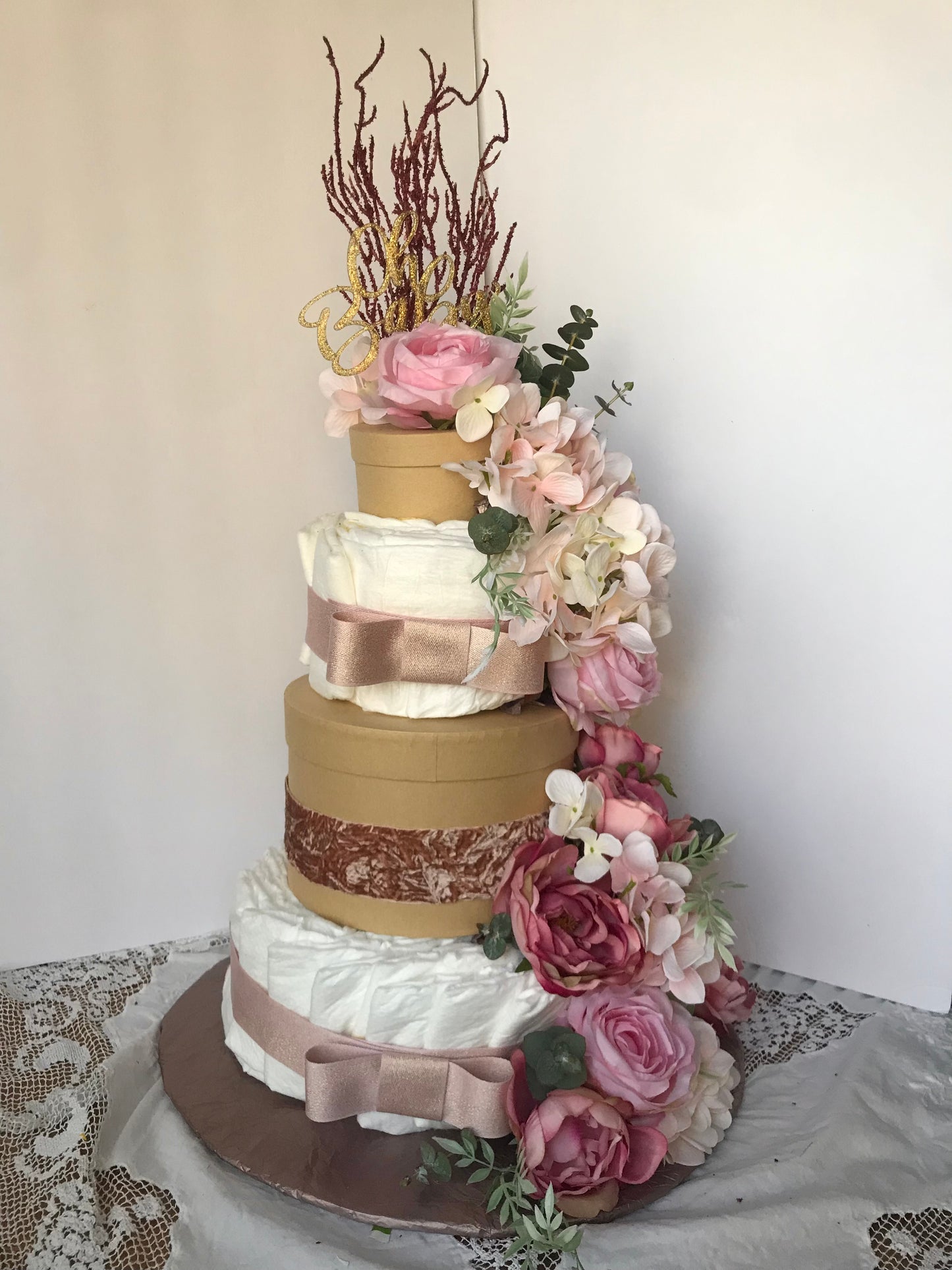 dusty rose luxury diaper cake with cascading flowers circular gift boxes 